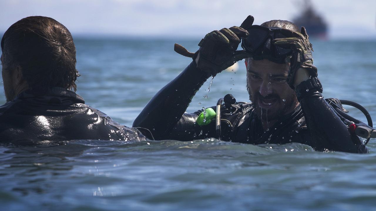 Royal Australian Navy Clearance Diver Petty Officer John Armfield collects explosive remnants of war from the shallow waters at Hells Point during Operation Render Safe 2016 in the Solomon Islands.