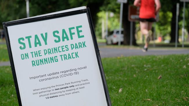 Caring authoritarianism: A safety sign sends a message to runners on the Princes Park track in Melbourne during the stage 4 lockdown. Picture: Getty Images