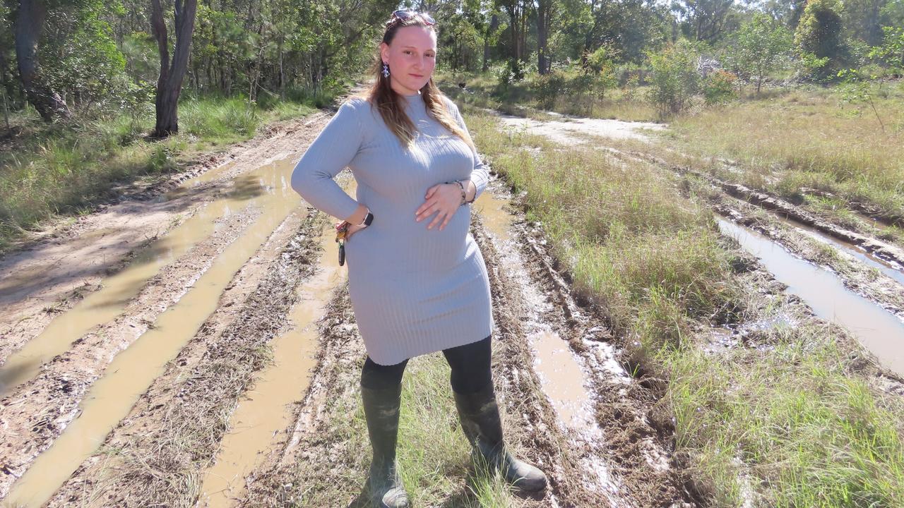 Mary Allen stands on what she believes is the worst section of the unformed part of Richards Road heading to her house.