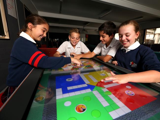 Tess Marlin, Ryan Tappouras, Daniel Merchant and Jessica Liddicoat use the electronic Promethean educational board / Picture: Adam Taylor