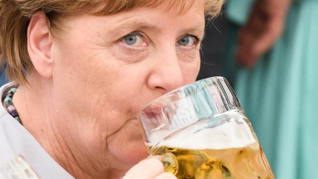 German Chancellor Angela Merkel drinks from a beer mug at the Trudering fest on 28 May 2017 in Munich, Germany. Picture: Sebastian Widmann/Getty Images