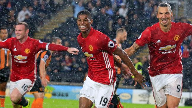 Manchester United's English striker Marcus Rashford (C) celebrates.