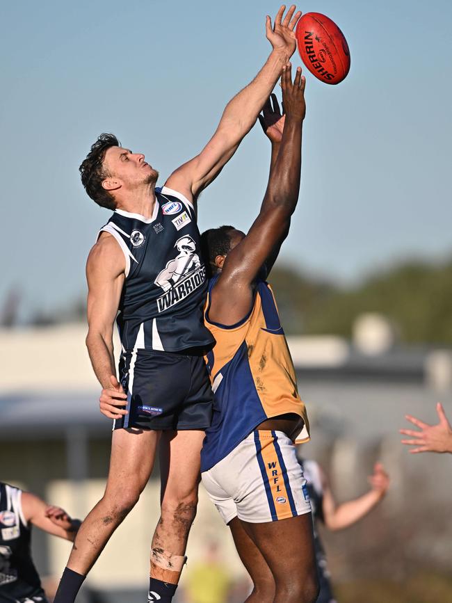 WRFL: Hoppers Crossing’s Harley Armstrong-Weston jumps over Adeola Akintola of Sunshine. Picture: Andy Brownbill