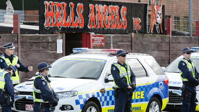 Police stand guard outside a Hells Angels clubhouse.