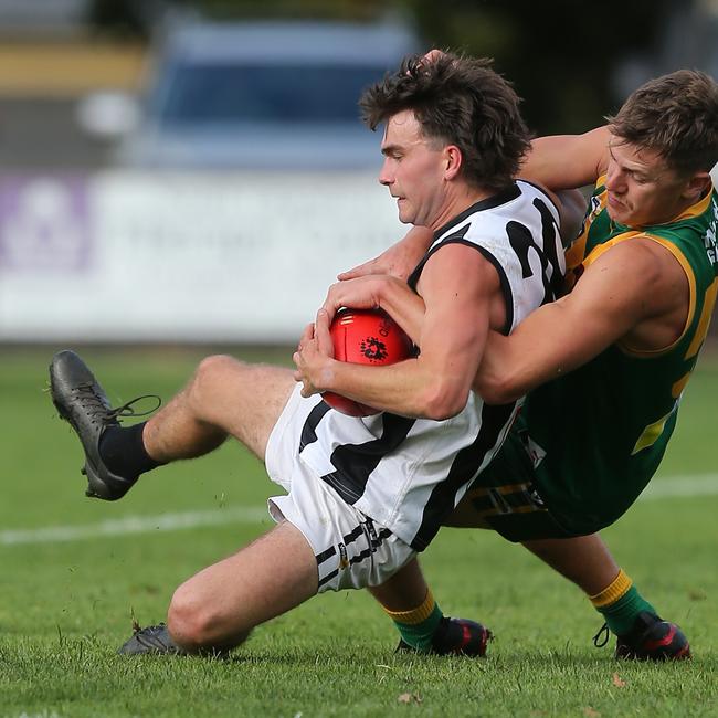 Leongatha’s Aaron Heppell tackles Sale’s Jake Hutchins. Picture: Yuri Kouzmin