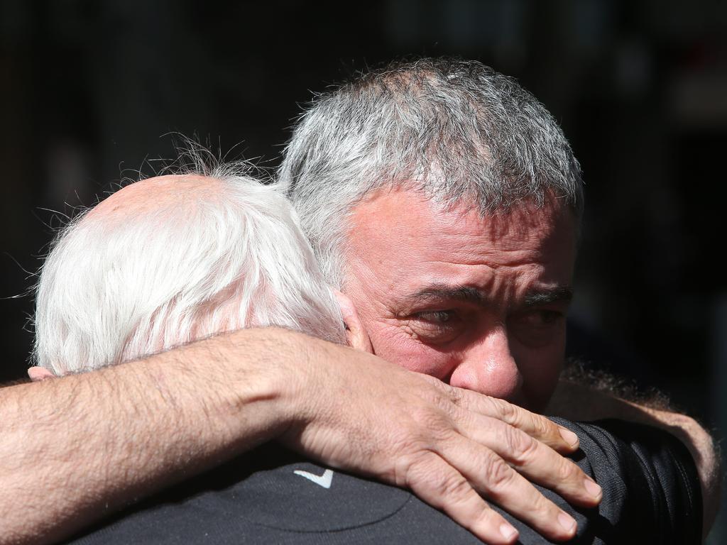 Nino Pangrazio, the business partner of murder victim Sisto Malaspina, hugs a friend near Pellegrini's Bar after learning of the tragedy. Picture: Yuri Kouzmin