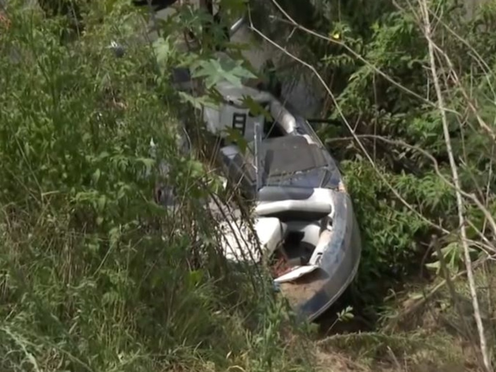 The boat Ms Jones was travelling in appears lodged under a tree on the bank of the Hawkesbury River at Wilberforce. Picture: Channel 7.