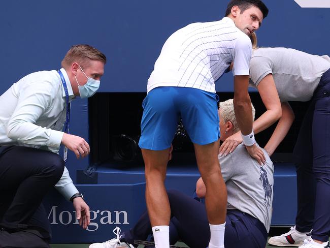 Novak Djokovic and US Open officials with fallen line judge Laura Clark. Picture: AFP