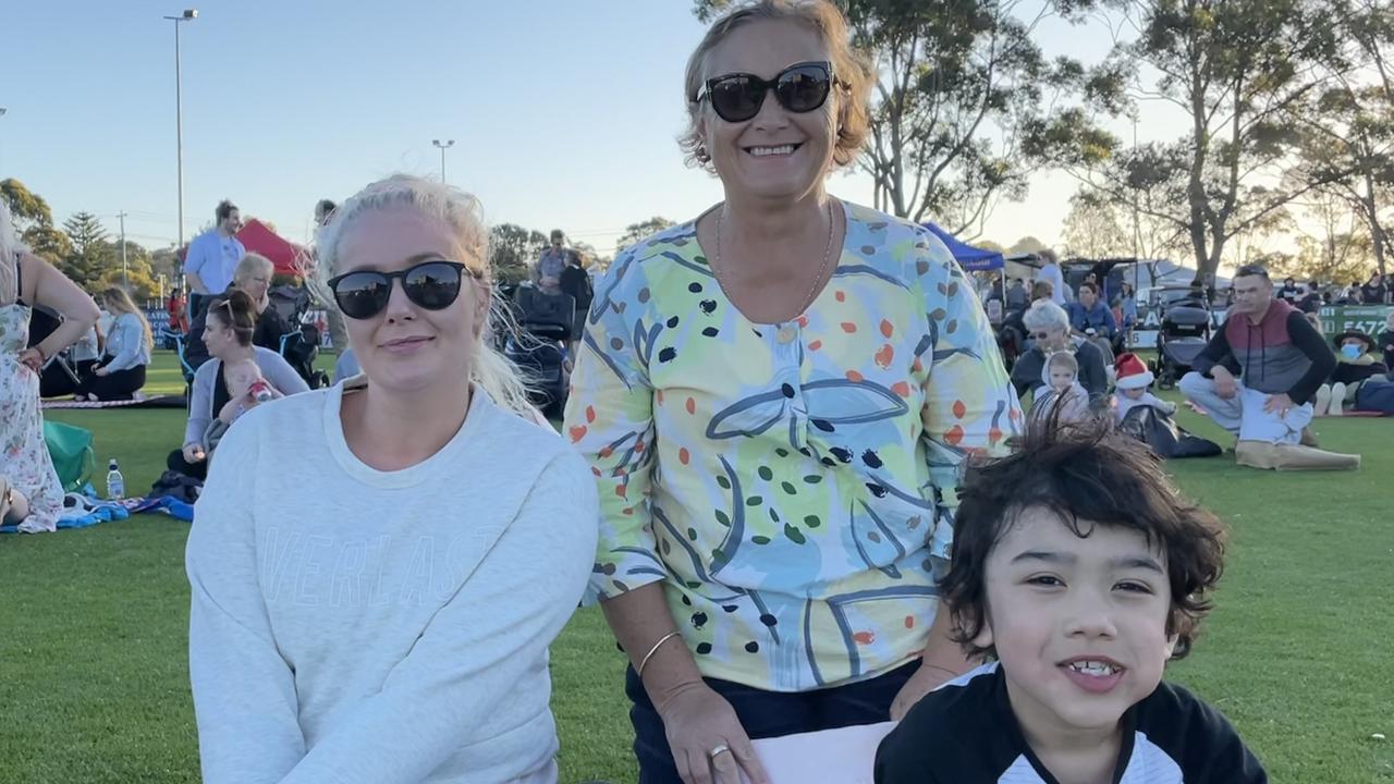 Eva O’Halloran, Naomi New and Jacob O’Halloran enjoying the freshly popped popcorn on Sunday.