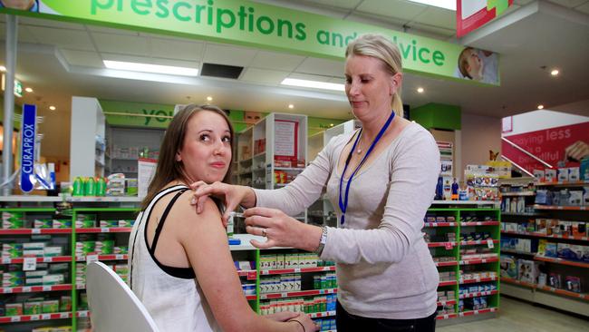 Many pharmacies are now using nurses to administer the flu vaccine to customers. Here nurse Kristine Ruhle vaccinates customer Alicia Ford at Priceline Pharmacy on George St, Sydney.