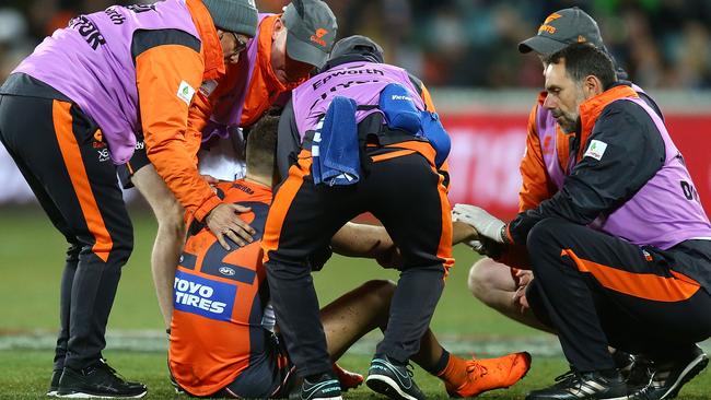 Josh Kelly of the Giants receives attention after a tackle during the round 21 AFL match between the Greater Western Giants and the Adelaide Crows at UNSW Canberra Oval on August 11, 2018 in Canberra, Australia. (Photo by Mark Nolan/Getty Images)