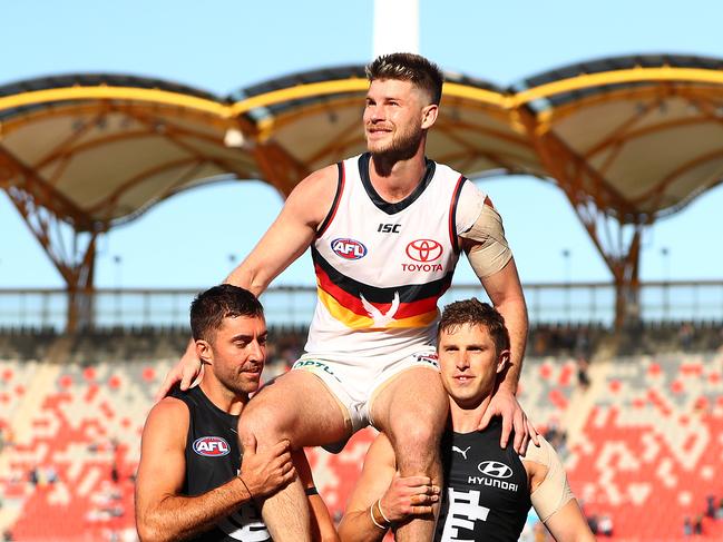 GOLD COAST, AUSTRALIA - SEPTEMBER 13: Bryce Gibbs of the Crows is chaired off by Kade Simpson and Marc Murphy of the Blues after playing in his final match during the round 17 AFL match between the Carlton Blues and the Adelaide Crows at Metricon Stadium on September 13, 2020 in Gold Coast, Australia. (Photo by Chris Hyde/Getty Images)