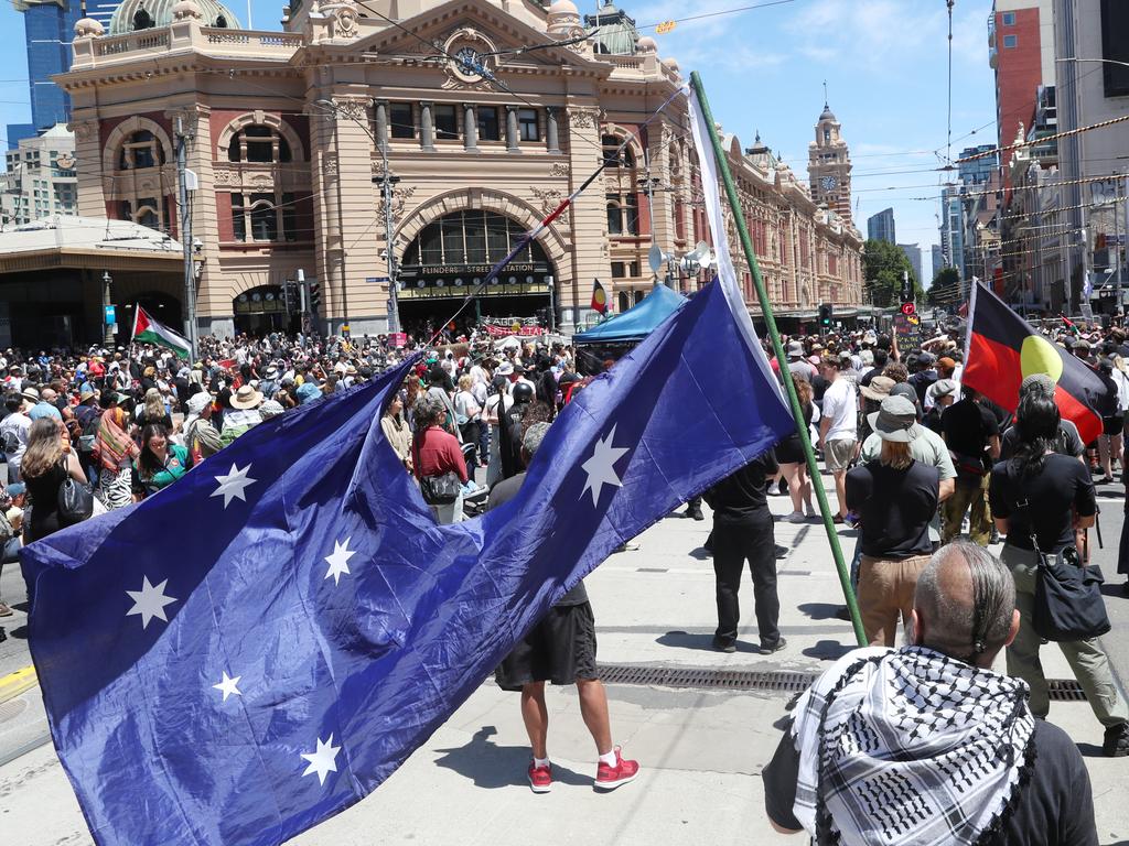 Protesters take over Flinders St and Swanston St intersection. Picture: David Crosling