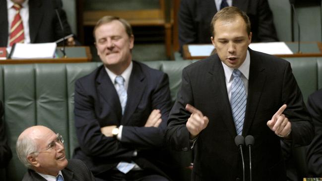 Prime Minister John Howard listens to assistant Treasurer Peter Dutton during House of Representatives question time at Parliament House Canberra in 2005.