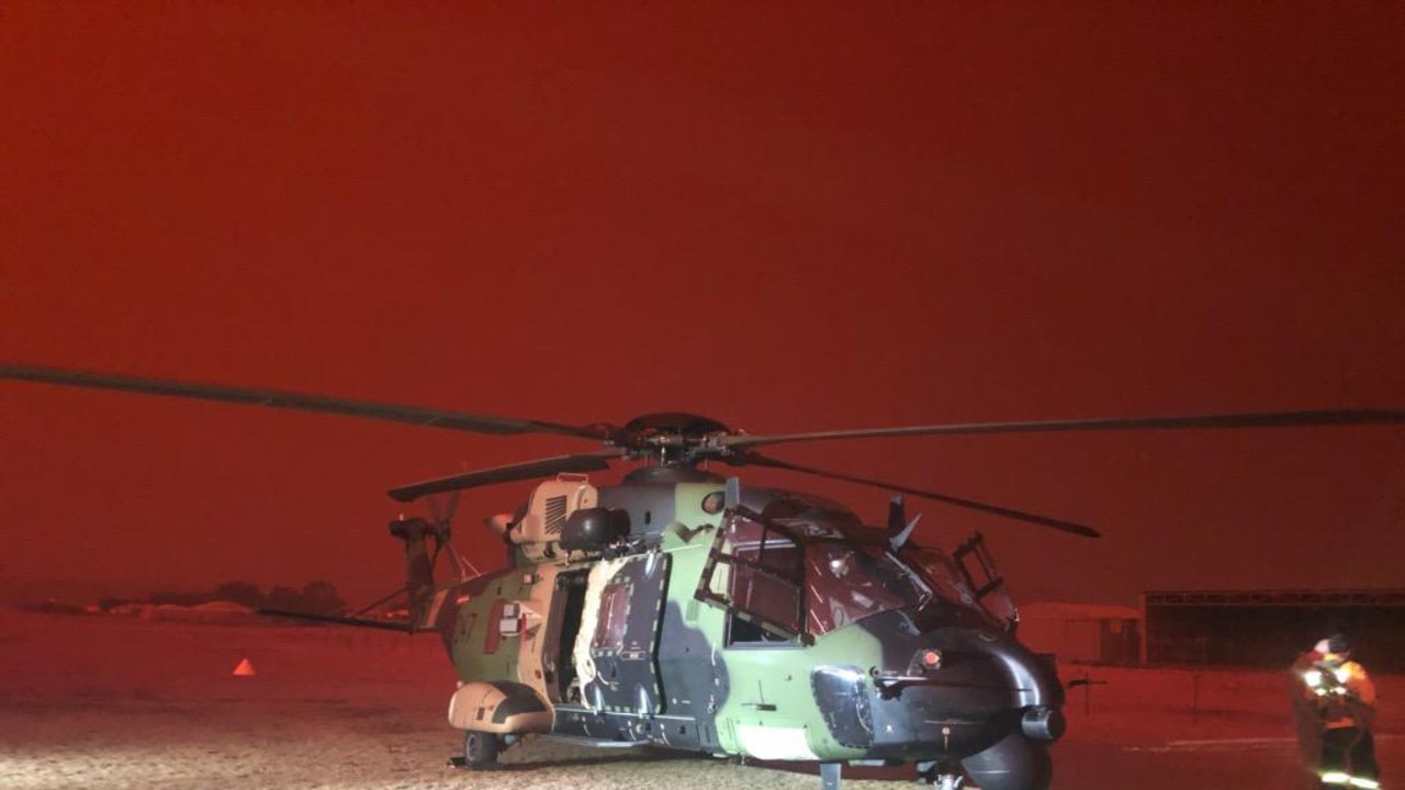 Australian Army 6th Aviation Regiment MRH90 providing support to RFS at Polo Flat, Cooma. *** Local Caption *** The Australian Defence Force (ADF) has commenced Operation Bushfire Assist 19-20 and has stood up Joint Task Forces in New South Wales and Victoria to enhance Defence support following devastating bushfires in the South East of Australia. ADF member are working side by side with emergency services personnel in the State Disaster Coordination Centre (SDCC) of the NSW Rural Fire Service Headquarters and alongside the Victorian Country Fire Service and Metropolitan Fire Brigades to provide best effect of ADF assets. HMAS Choules, MV Sycamore and Royal Australian Navy MRH-90 helicopters have conducted evacuations of people and animals from the fire-affected Victorian coastal town of Mallacoota. The Canberra Class Landing Helicopter Dock (LHD) HMAS Adelaide has also sailed from Sydney this afternoon to join the bushfire relief efforts and support the evacuation of people from fire-affected communities. The ADF is also providing transport and other assistance such as aviation ground support, logistics, engineering and accommodation support to the firefighting effort.