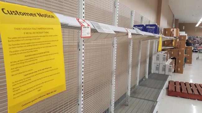 Empty toilet paper shelves at Coles.