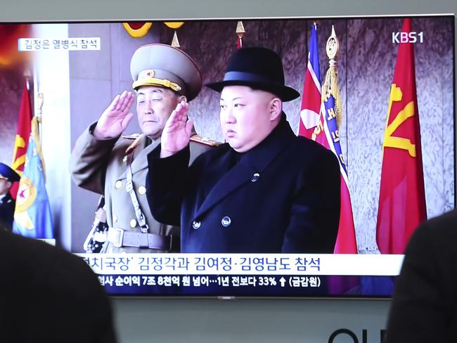 People watch a TV showing North Korean leader Kim Jong-un during yesterday’s military parade. Picture: Ahn Young-joon/AP