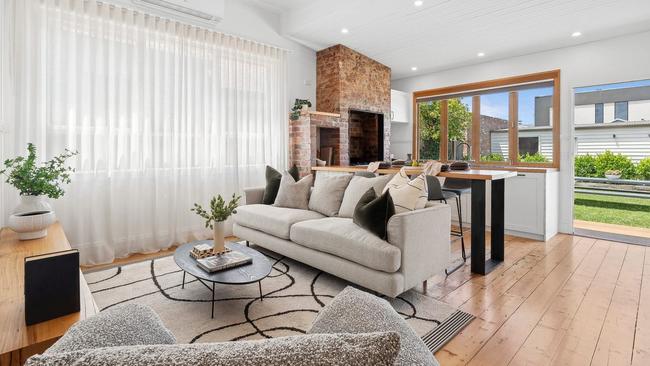 The open-plan living area opens to the backyard, with a studio at the rear of the property.