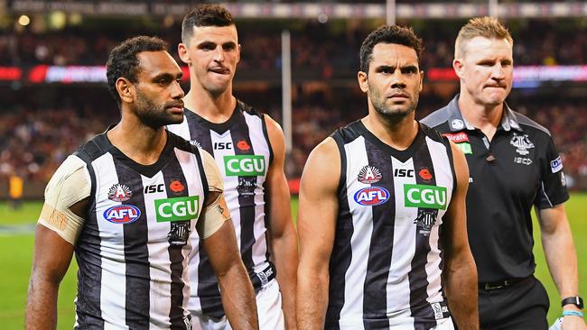 Travis Varcoe, Scott Pendlebury, Daniel Wells and Nathan Buckley look dejected. (Photo by Quinn Rooney/Getty Images)