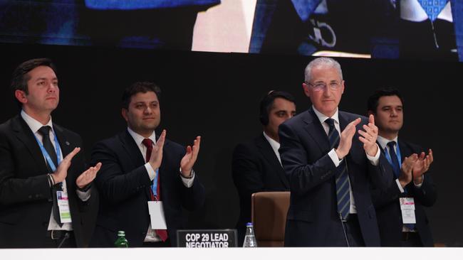 President Mukhtar Babayev (2nd from right) and Yalchin Rafiyev (left), applaud the end of the UNFCCC COP29 Climate Conference in the early hours on Sunday in Baku, Azerbaijan. Picture: Sean Gallup/Getty Images