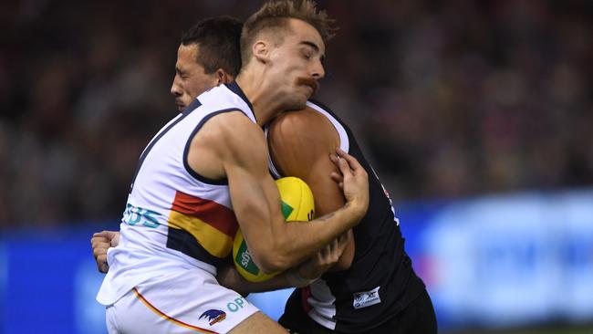 Jordan Gallucci cops a big bump from Ben Long but got up and released the handball under pressure. Picture: Julian Smith (AAP).