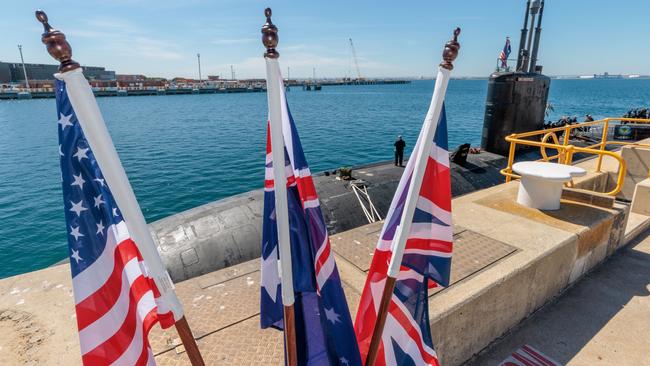 National flags of the USA, Australia and Great Britain are seen in front of the USS Asheville, a Los Angeles-class nuclear powered fast attack submarine at HMAS Stirling as part of the AUKUS deal. Picture: NCA NewsWire