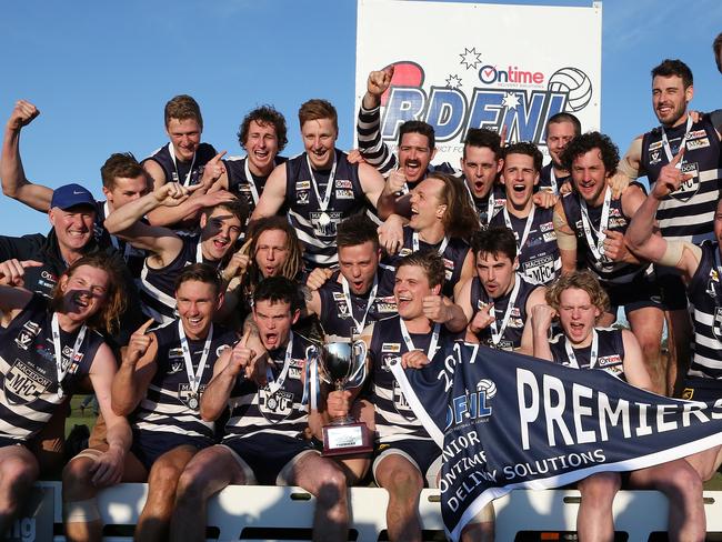 RDFL grand final: Macedon v Rupertswood. 16th September.   Macedon coach Jeff Andrews and captain James Wright hold aloft the premiership trophy as the Macedon team celebrates the win.Picture : George Salpigtidis