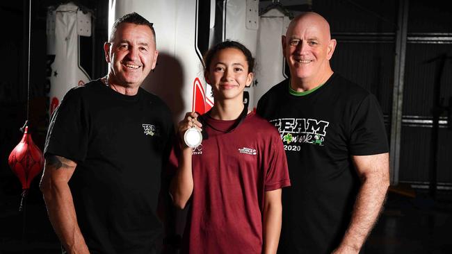 Shamrock Boxing coaches Mike Foley (left) and Kip Daddo (right) with rising boxer Tiana Rew and her gold medal following her win at the Australian titles. Picture: Patrick Woods.