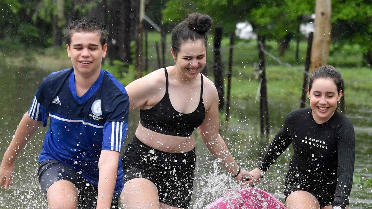 Wet weather in Townsville. Matty, 14, Lexie, 16, and Charlie Wendt, 11, enjoy the rain in Kelso. Picture: Evan Morgan