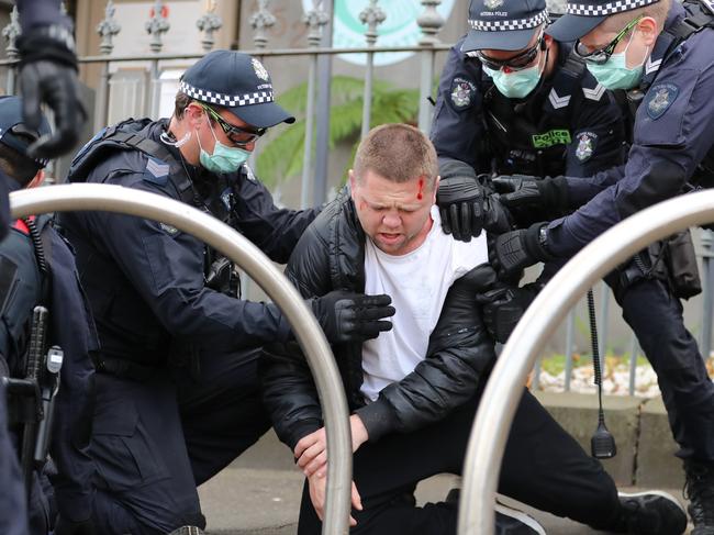 Nick Patterson is thrown to the ground during his arrest.