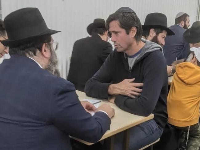 Gillon shares a private moment with a Rabbi in a Queens synagogue.