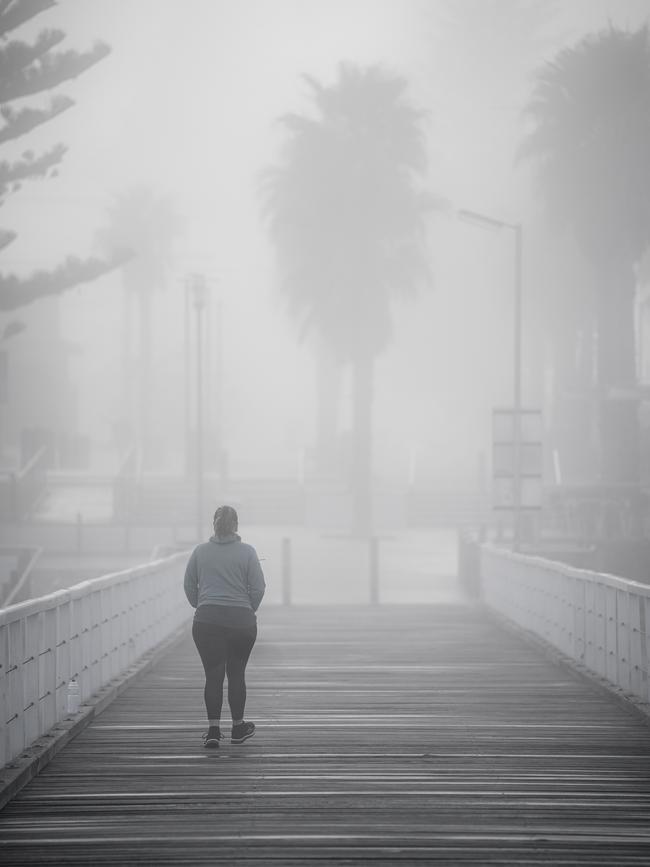 A walker at Grange Beach, Sunday, August 16. Picture: MIKE BURTON