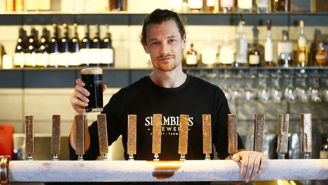 Many local breweries produce special winter beers, including Shambles Brewery in North Hobart where bar attendant Will Caught is pictured with a winter beer. Picture: MATT THOMPSON