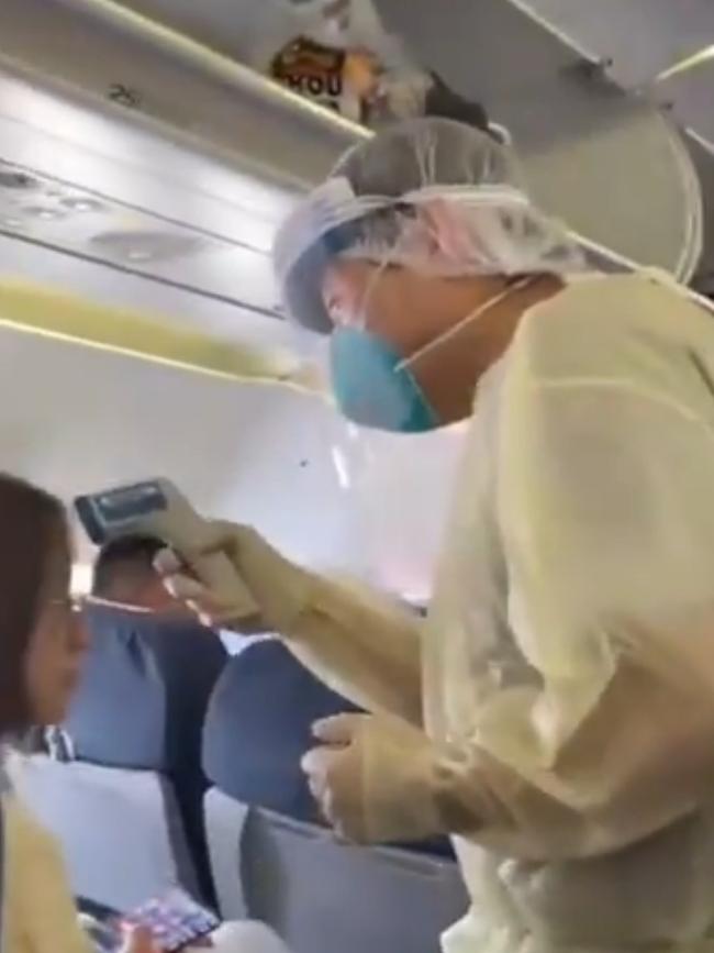 A medical specialist takes a passenger’s temperature. Picture: Twitter.