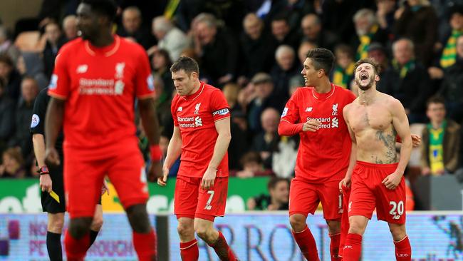 Adam Lallana of Liverpool (1st R) celebrates scoring his team's fifth goal.