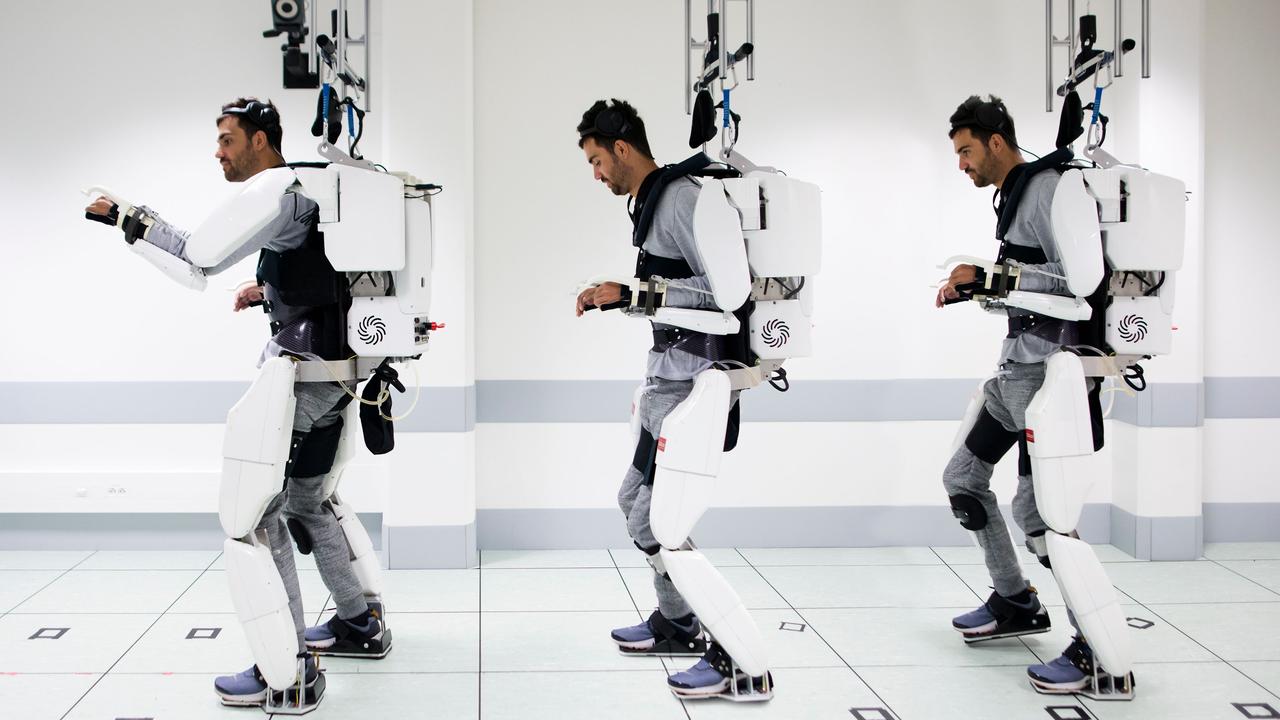This combination of photos shows the quadriplegic man standing, walking and moving his arm while wearing the exoskeleton at The University of Grenoble, France. Picture: AFP/Clinatec Endowment Fund