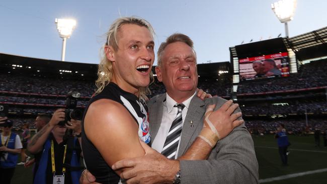 Darcy Moore gets a hug from his father Peter after the win. Picture: David Caird