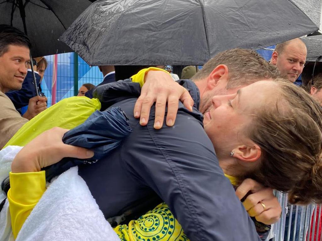 Australian cyclist Grace Brown embraces her husband Elliott Smith after winning the individual time trial at the 2024 Paris Olympics.