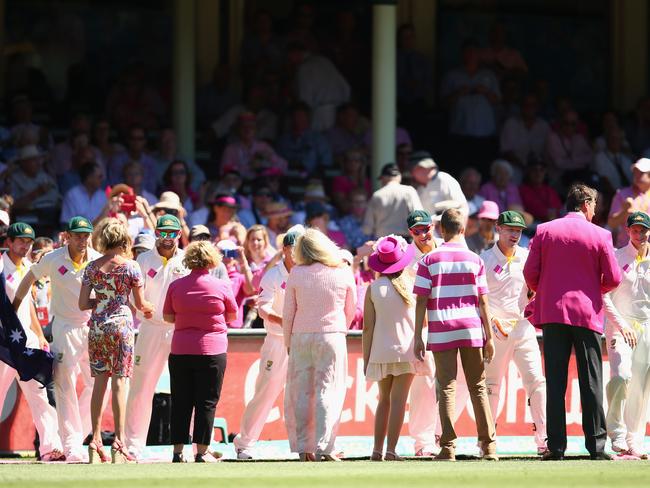 Australian captain Steve Smith and the Australian team are welcomed by former Australian cricketer Glenn McGrath as they walk onto the field for 'Jane McGrath Day' on January 8, 2015 in Sydney.