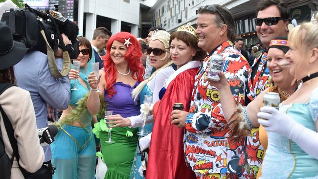 Colourful costumes the choice for these racegoers. Picture: AFP