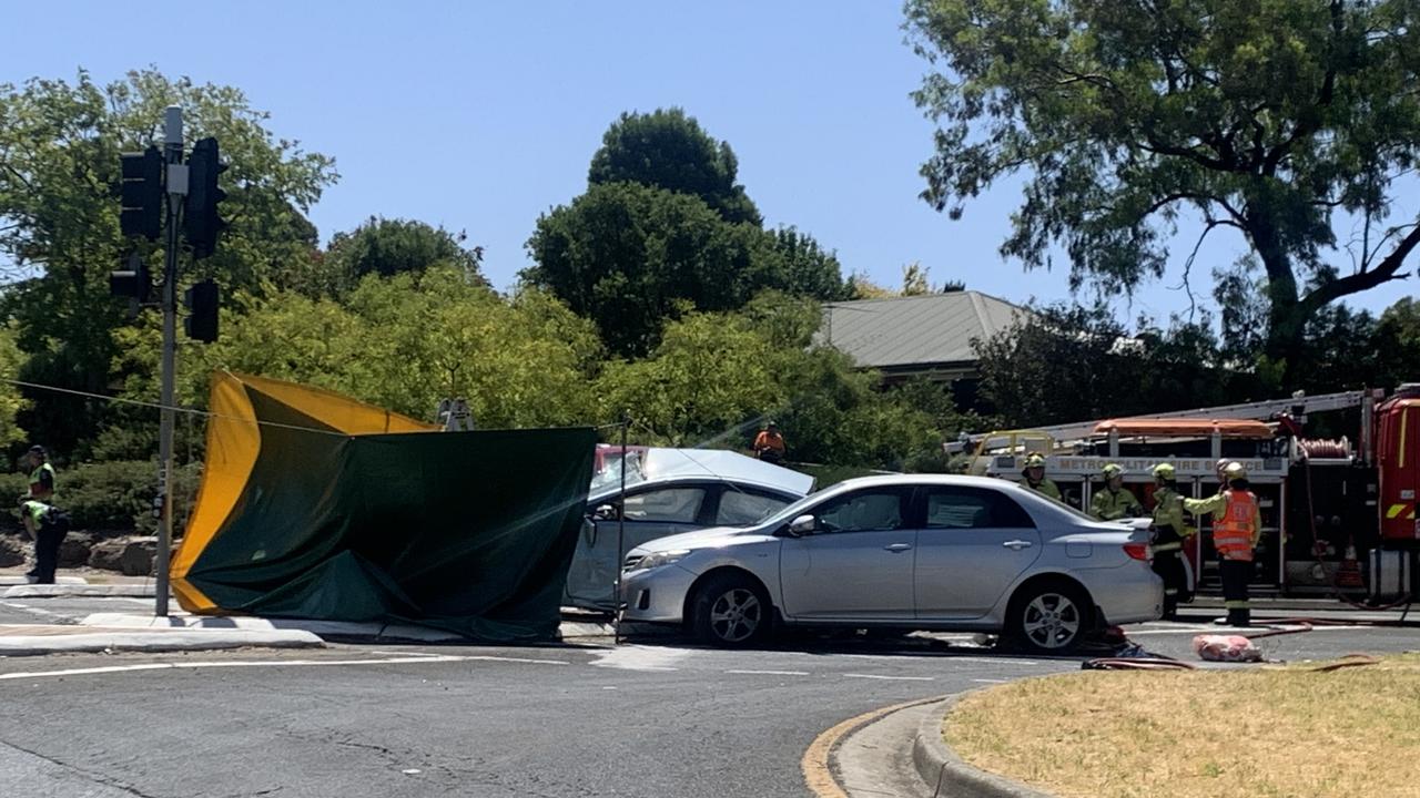 Fatal car crash at Golden Grove, Adelaide, 28 February 2024: Emergency services put up a screen around the crash which involved a silver sedan and red four-wheel drive. Picture: George Yankovich