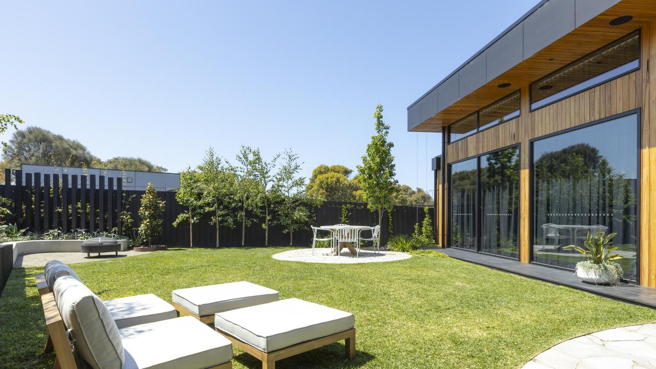 North-facing backyard with a built-in BBQ, firepit, and alfresco dining.