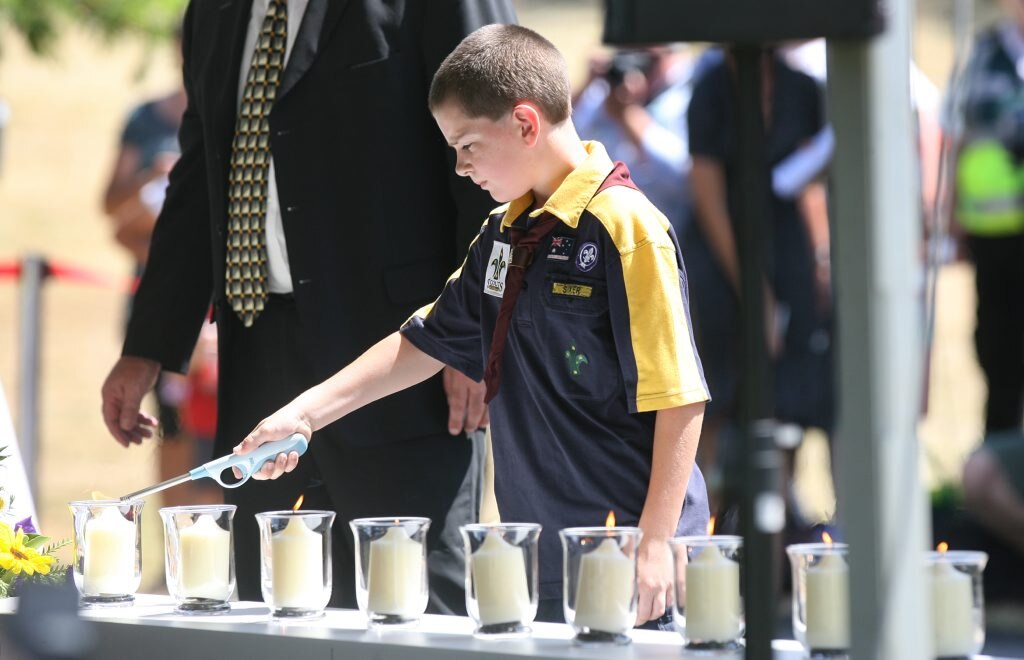 Lighting candles at the Gatton commemorative flood service at the Lockyer Valley Cultural Centre. Photo: Rob Williams / The Queensland Times. Picture: Rob Williams