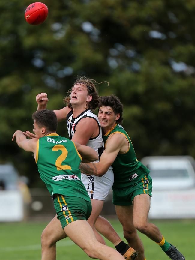 Sale’s Jack McLaren is sandwiched between two Leongatha opponents. Picture: Yuri Kouzmin