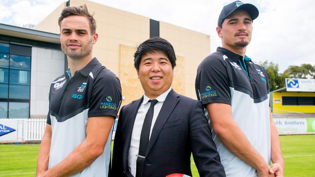 Nicho Teng (Greaton managing director) with Port players Karl Amon and Sam Powell-Pepper.