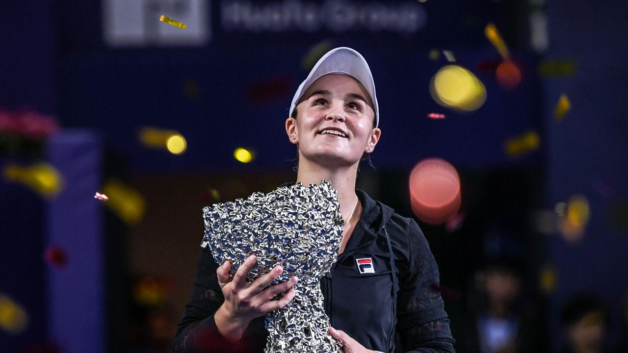 Ashleigh Barty of Australia holds the trophy after winning the women's singles final match against Wang Qiang.