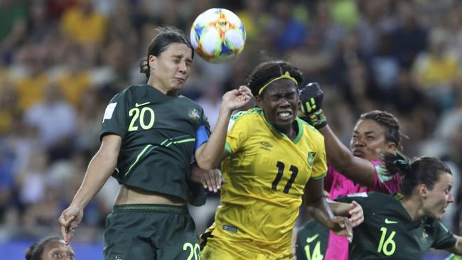 Australia's Sam Kerr, top left, jumps for the ball with Jamaica's Khadija Shaw, center, during the Women's World Cup Group C soccer match between Jamaica and Australia at Stade des Alpes stadium in Grenoble, France, Tuesday, June 18, 2019. (AP Photo/Laurent Cipriani)