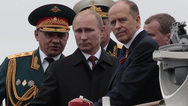 Russian President Vladimir Putin flanked by Defence Minister Sergei Shoigu and Federal Security Service Chief Alexander Bortnikov in Crimea. Picture: Ivan Sekretarev