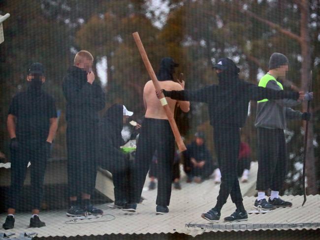 Inmates from the Frank Baxter Juvenile corrections centre Kariong taunt police from the roofs of various buildings. Some are armed with poles tennis rackets ect. Picture: John Grainger