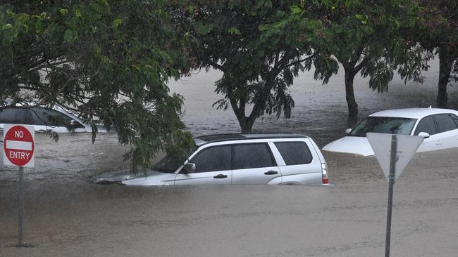 Cars sit in flood waters outside the Robina Hospital on the Gold Coast in March 2017 after a severe rain depression caused by ex-Tropical Cyclone Debbie. Picture: AAP Image/Dave Hunt.